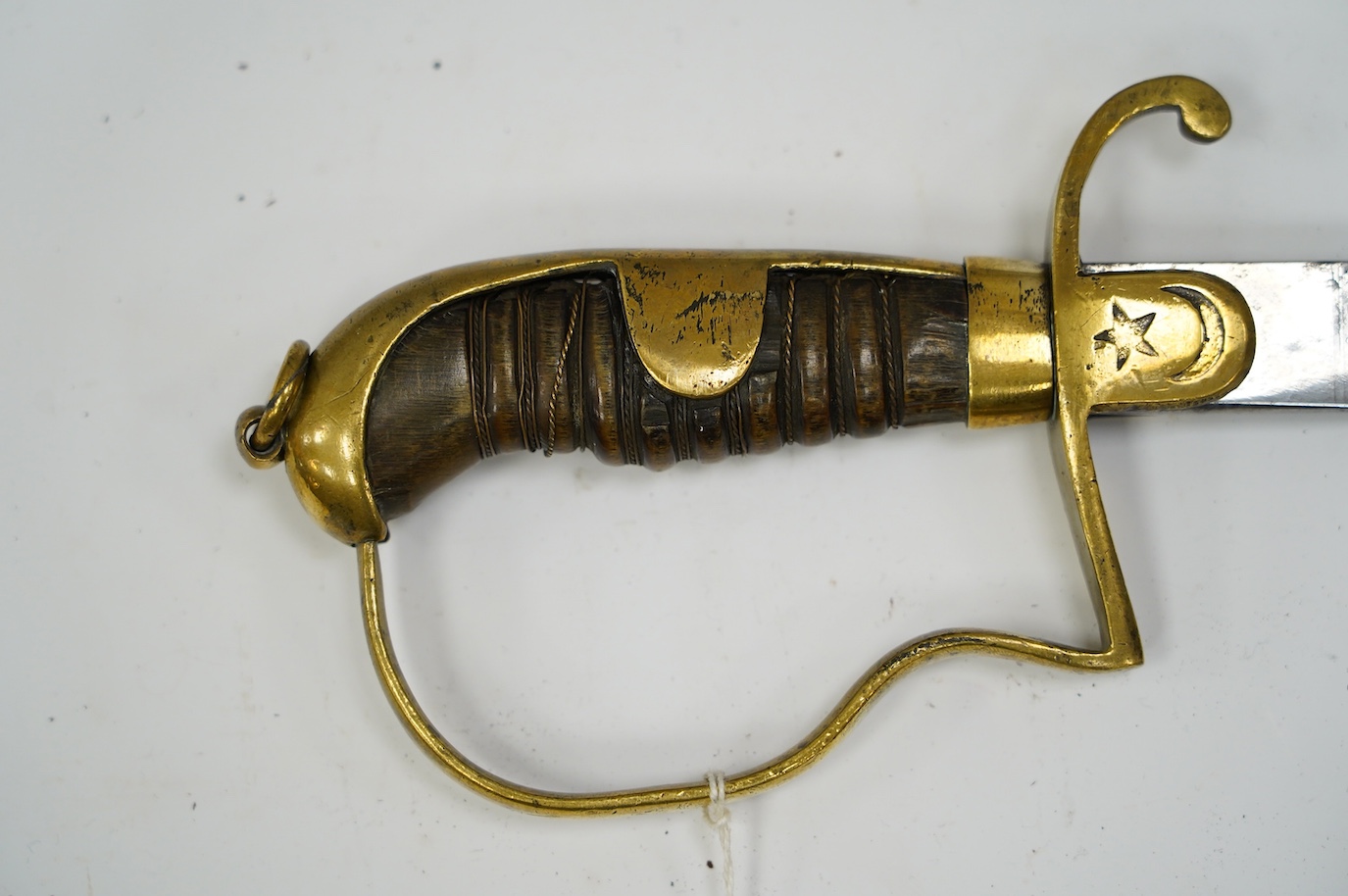 A Turkish WWI artillery sword, etched blade, Vanran Tagirian, Constantinople, brass stirrup hilt and horn grip, blade 70.5cm. Condition - fair, well worn